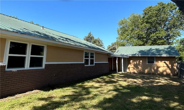 view of side of property with a yard