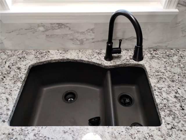 room details with light stone counters and sink