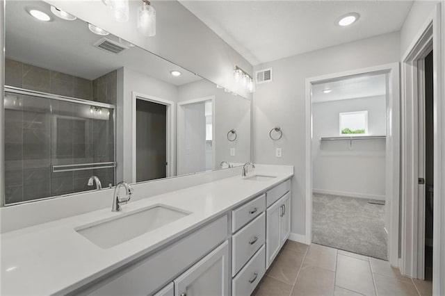780 Creekmoor Dr, Raymore, MO 64083 - full bathroom with double vanity, a shower stall, tile patterned flooring, recessed lighting, and baseboards
