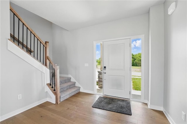 780 Creekmoor Dr, Raymore, MO 64083 - foyer with hardwood / wood-style floors, stairway, and baseboards