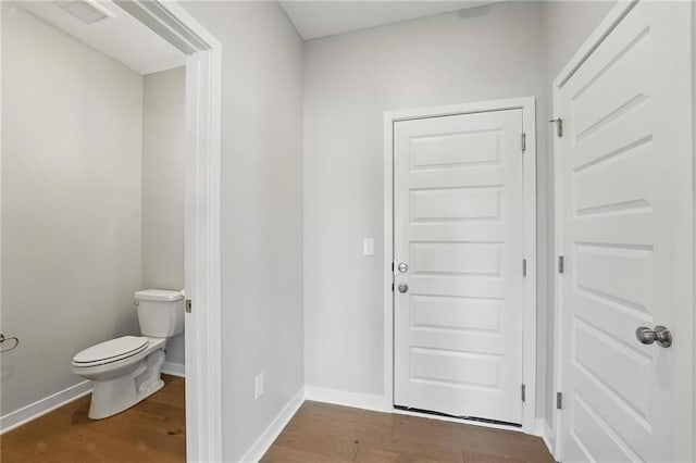 780 Creekmoor Dr, Raymore, MO 64083 - bathroom with toilet, wood finished floors, and baseboards