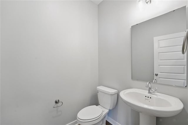 780 Creekmoor Dr, Raymore, MO 64083 - bathroom with baseboards, a sink, and toilet