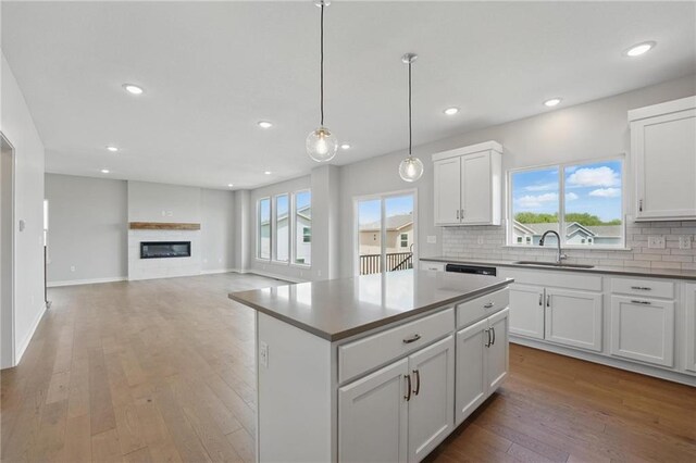780 Creekmoor Dr, Raymore, MO 64083 - kitchen with a sink, backsplash, recessed lighting, light wood finished floors, and white cabinets