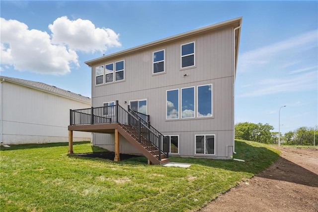780 Creekmoor Dr, Raymore, MO 64083 - back of property with stairway, a deck, and a lawn