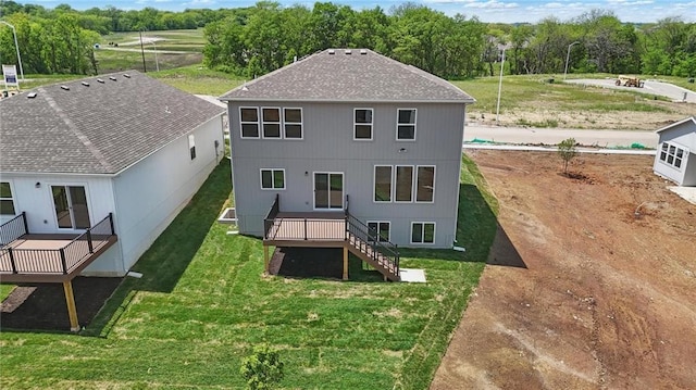 780 Creekmoor Dr, Raymore, MO 64083 - rear view of property with stairway, a wooden deck, a yard, and roof with shingles