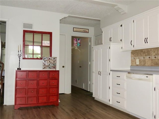 kitchen featuring white dishwasher, backsplash, white cabinetry, dark wood-type flooring, and a textured ceiling