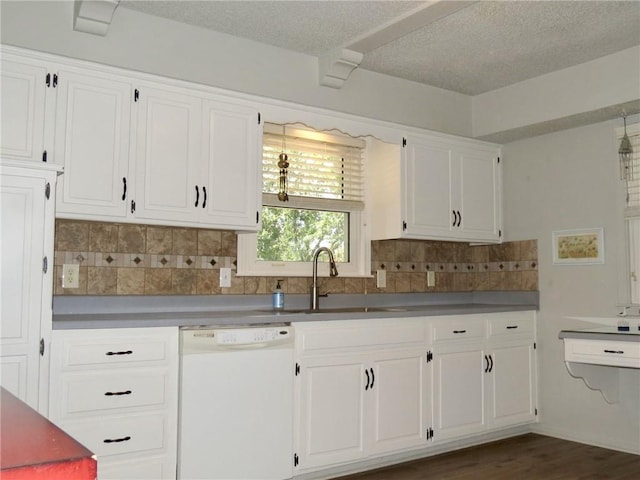 kitchen with white cabinets, tasteful backsplash, and dishwasher