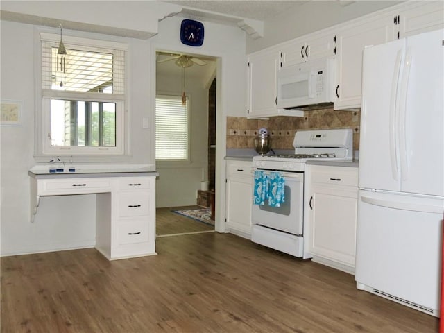 kitchen featuring decorative light fixtures, white appliances, white cabinets, and decorative backsplash