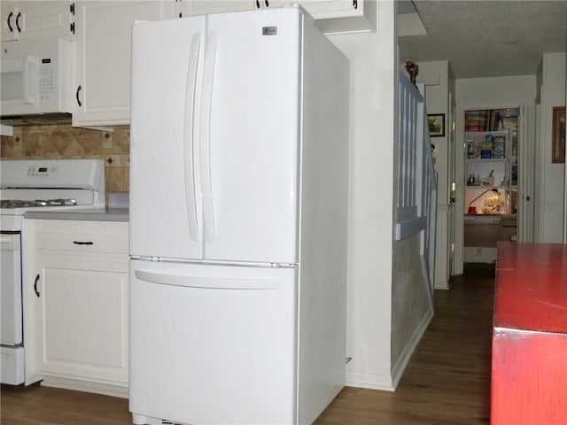 kitchen with backsplash, white appliances, white cabinets, and dark hardwood / wood-style flooring