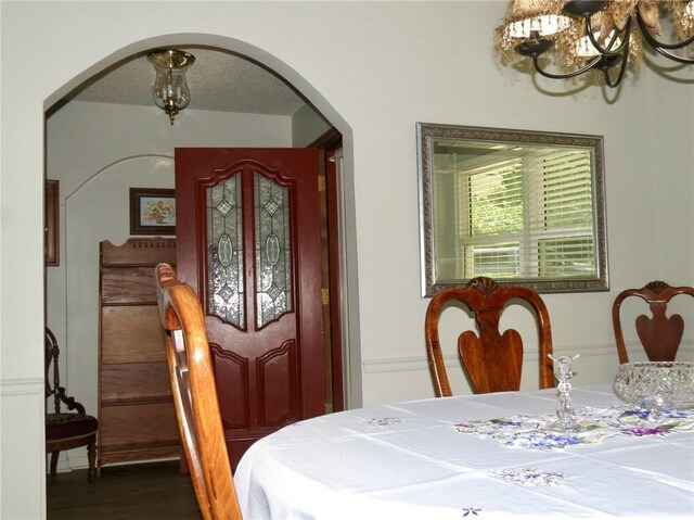 dining space with dark hardwood / wood-style flooring