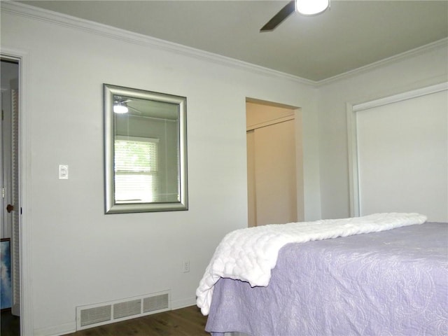 bedroom featuring dark hardwood / wood-style flooring, ceiling fan, and ornamental molding