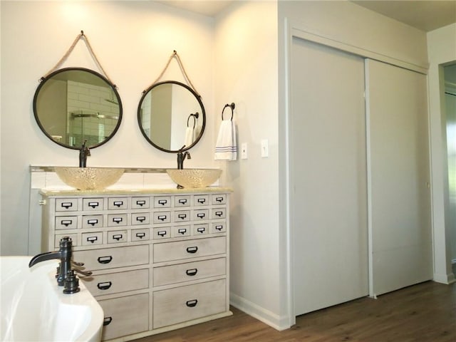 bathroom with vanity and hardwood / wood-style flooring