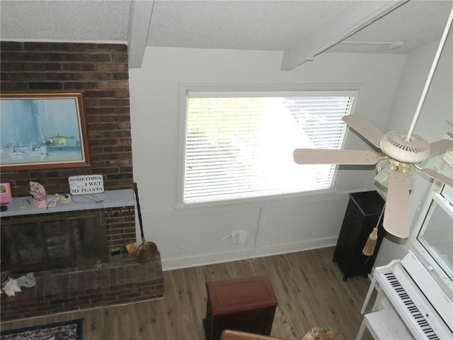 living room featuring beam ceiling and wood-type flooring