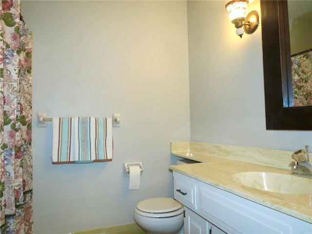 bathroom with toilet and vanity