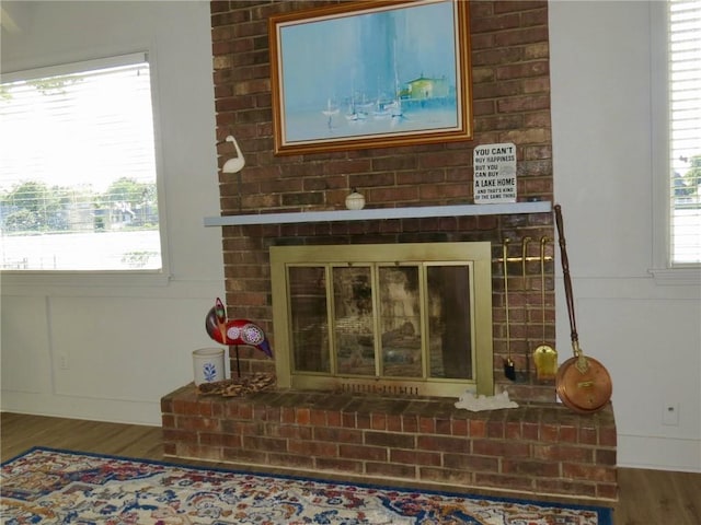 interior details featuring a fireplace and wood-type flooring