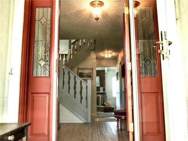 1005 Johnston Dr, Raymore, MO 64083 - foyer entrance with stairs and wood finished floors