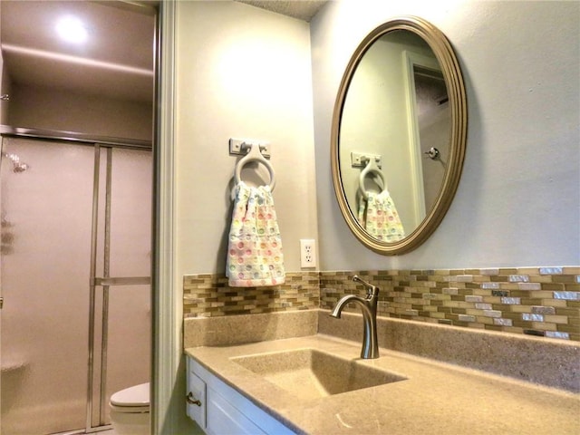 1005 Johnston Dr, Raymore, MO 64083 - bathroom featuring a shower stall, vanity, and toilet