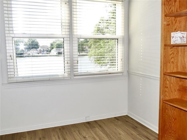 1005 Johnston Dr, Raymore, MO 64083 - unfurnished dining area featuring wood finished floors and baseboards