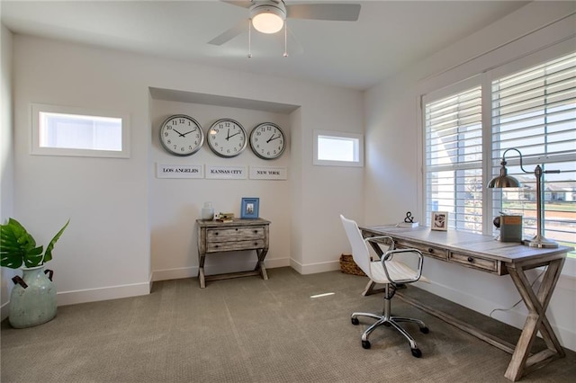 carpeted home office featuring ceiling fan