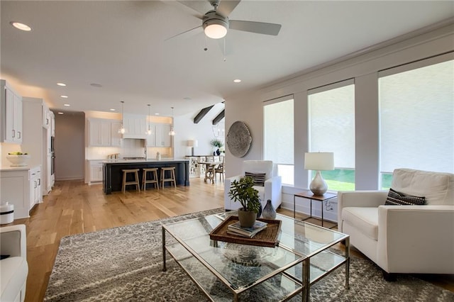 living room featuring hardwood / wood-style flooring and ceiling fan