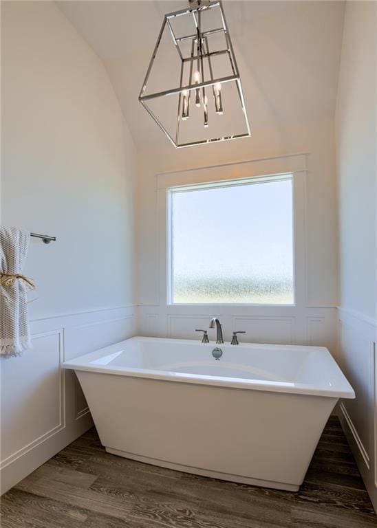 bathroom featuring hardwood / wood-style flooring, a healthy amount of sunlight, and a washtub