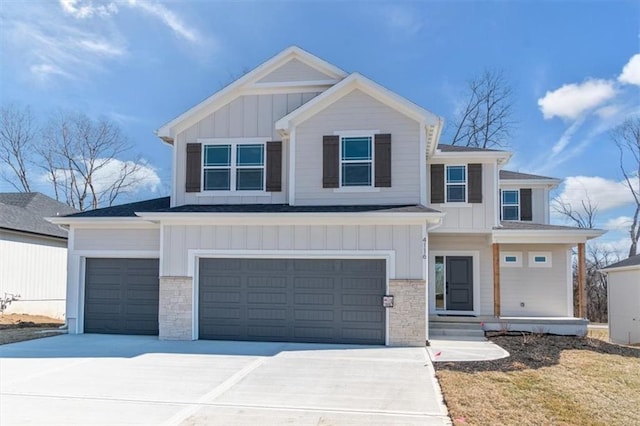 view of front of home with concrete driveway, board and batten siding, and stone siding