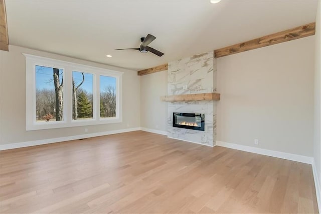 unfurnished living room featuring recessed lighting, a fireplace, a ceiling fan, baseboards, and light wood finished floors