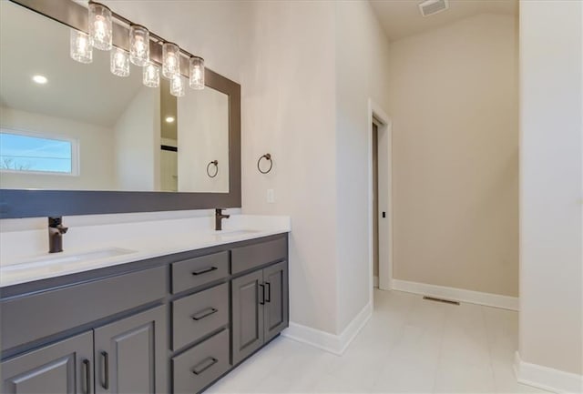 full bath with lofted ceiling, baseboards, visible vents, and a sink