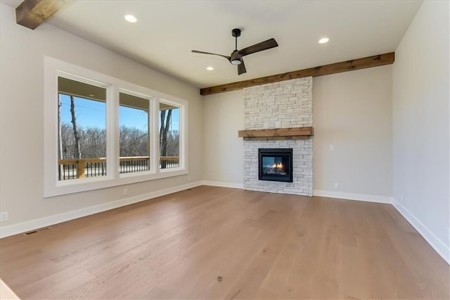 unfurnished living room with recessed lighting, baseboards, beamed ceiling, and wood finished floors