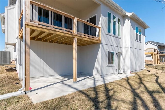 rear view of property with central AC unit