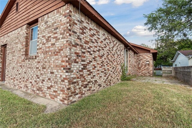 view of side of property with a yard