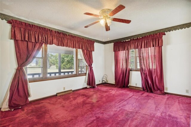 spare room with a baseboard radiator, ceiling fan, and carpet flooring