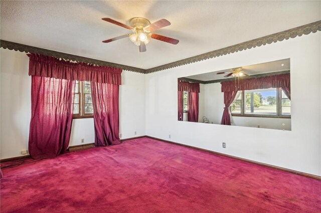 spare room with a textured ceiling, ceiling fan, and carpet floors