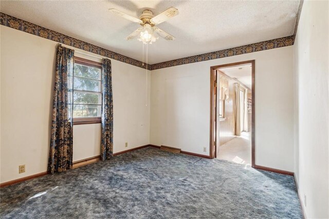 carpeted empty room featuring a textured ceiling and ceiling fan