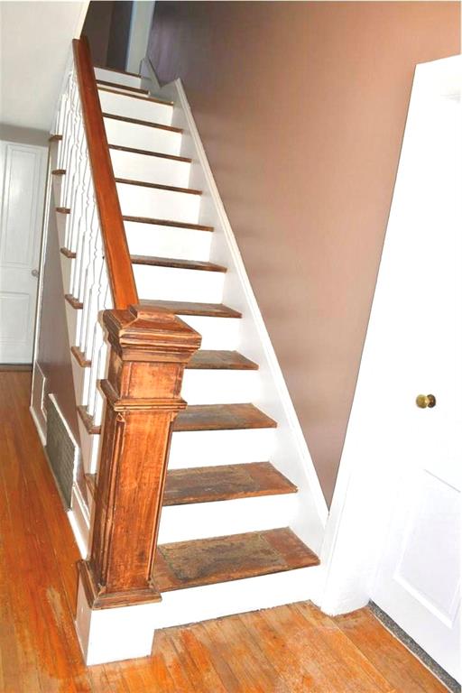 stairs featuring hardwood / wood-style flooring