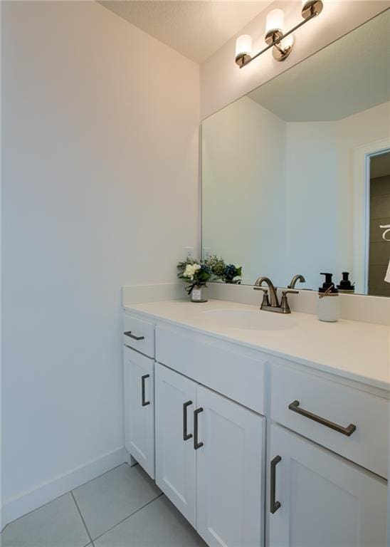 bathroom featuring tile patterned floors, baseboards, and vanity