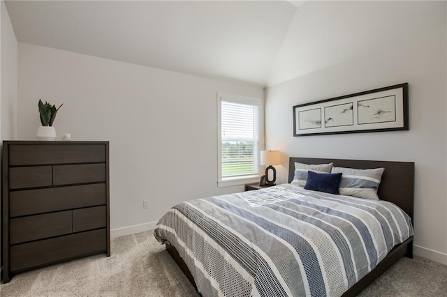 bedroom featuring light carpet and vaulted ceiling