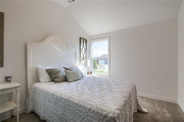 bedroom featuring lofted ceiling and carpet