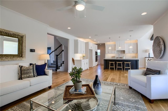 living room with stairway, wood finished floors, and recessed lighting