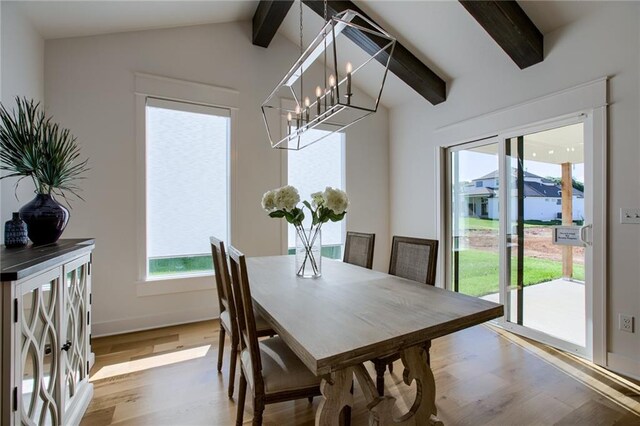 dining room featuring vaulted ceiling with beams, hardwood / wood-style flooring, and a chandelier