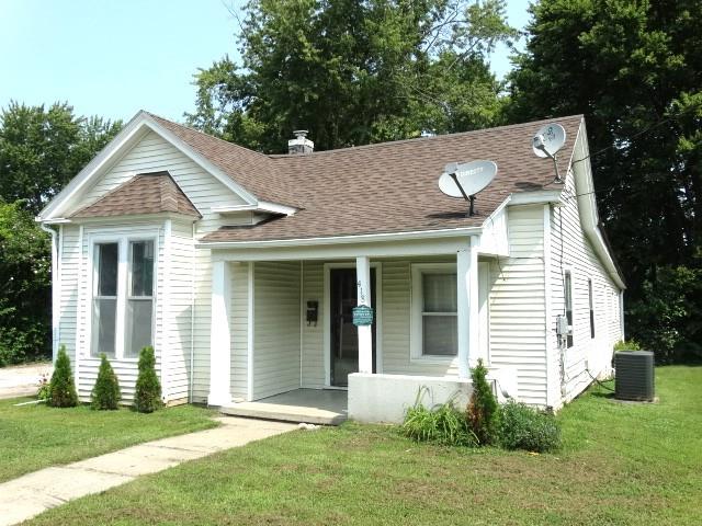 bungalow with central AC and a front yard