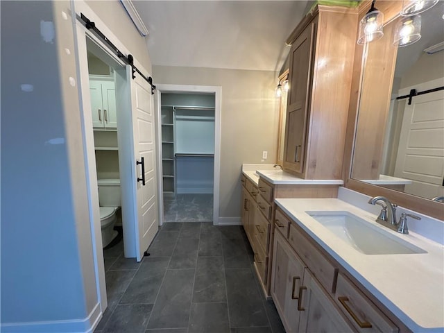 bathroom featuring vanity and toilet