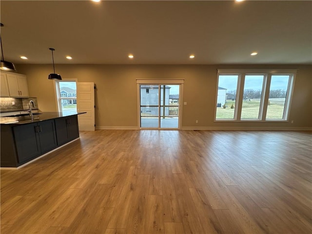 unfurnished living room with plenty of natural light and light wood-type flooring