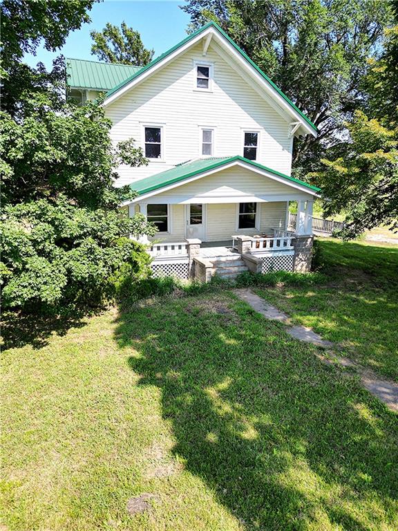 back of property featuring a lawn