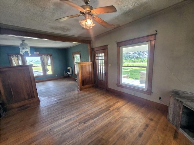 interior space with a textured ceiling, wood-type flooring, a healthy amount of sunlight, and ceiling fan