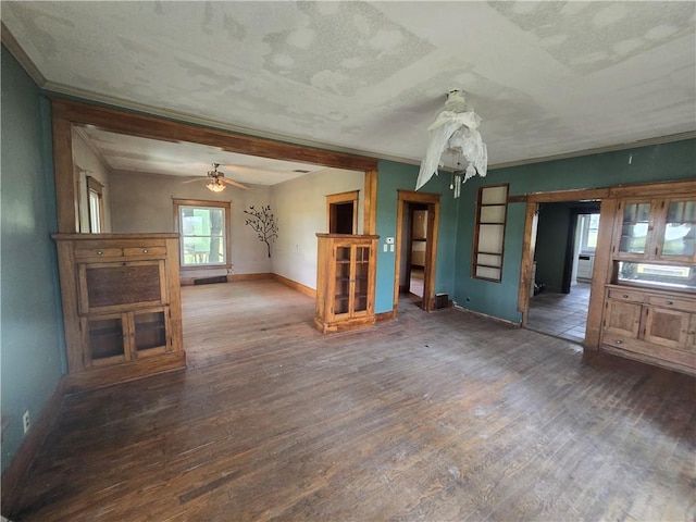 unfurnished living room with a textured ceiling, ceiling fan, and hardwood / wood-style floors