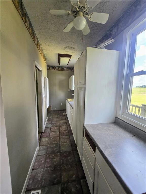 corridor with dark tile patterned floors