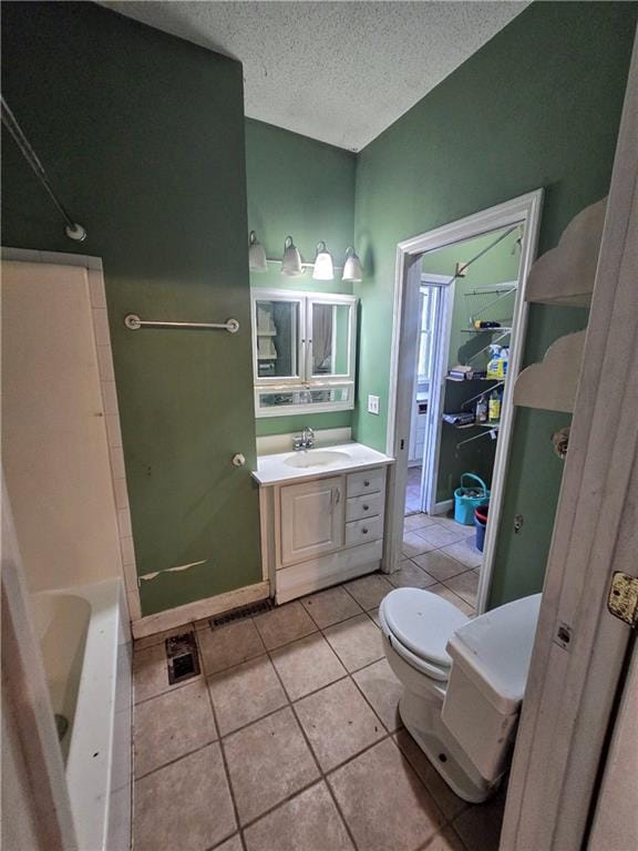 full bathroom with tile patterned flooring, shower / washtub combination, a textured ceiling, toilet, and vanity