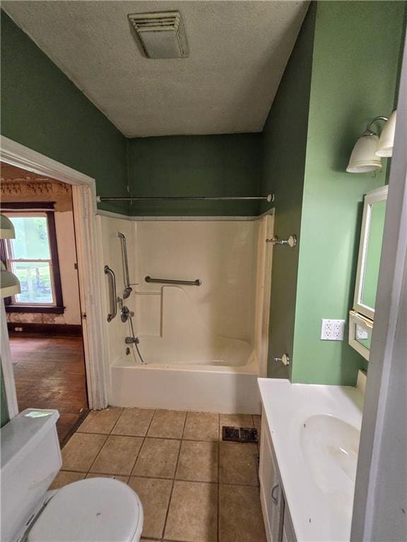 full bathroom featuring vanity, shower / bath combination, tile patterned flooring, and toilet