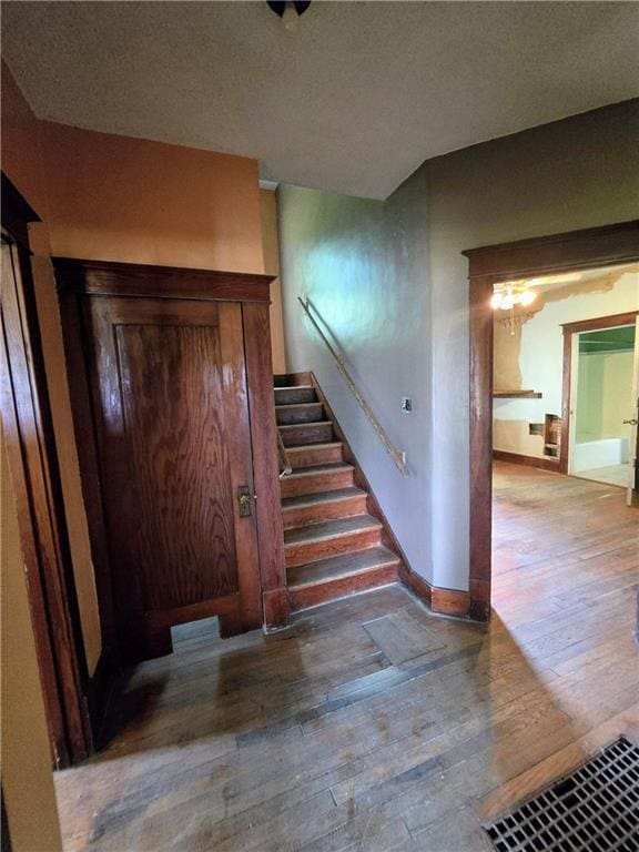 stairs featuring wood-type flooring